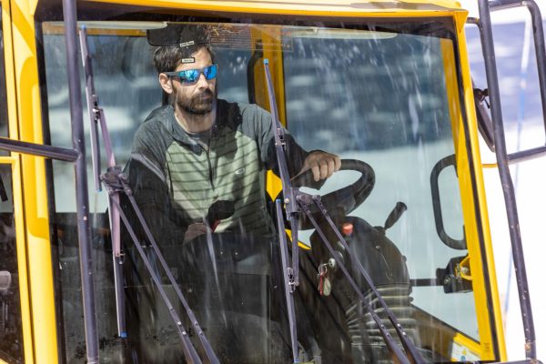 Valente uses a steering wheel to navigate the snowcat and a joystick to control the blade.