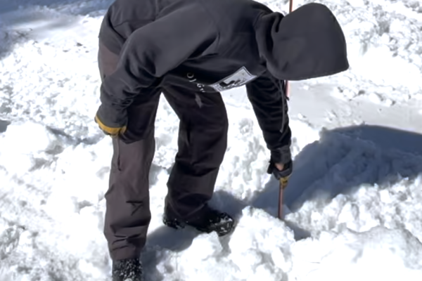 Old Greenwood Superintendent Dave Martin measures the depth of snow on the 1st green of Old Greenwood.